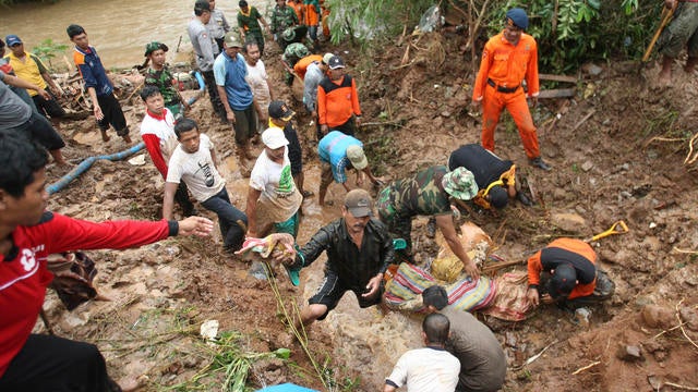 Rescuers search for the victims of a landslide in Jombang, East Java, Indonesia 