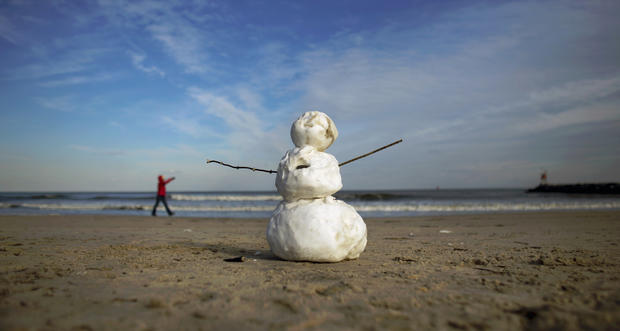 A snowman stands on the beach with temperatures around freezing near Rudee inlet in Virginia Beach, Va., Jan. 23, 2014. 
