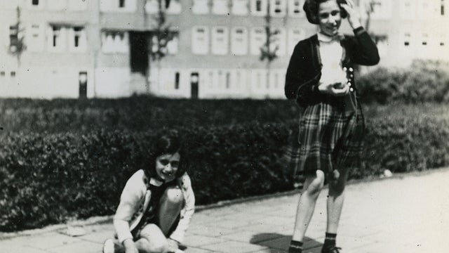 Anne Frank, left, plays with her friend Hanneli Goslar, right, on the Merwedeplein square in Amsterdam.  