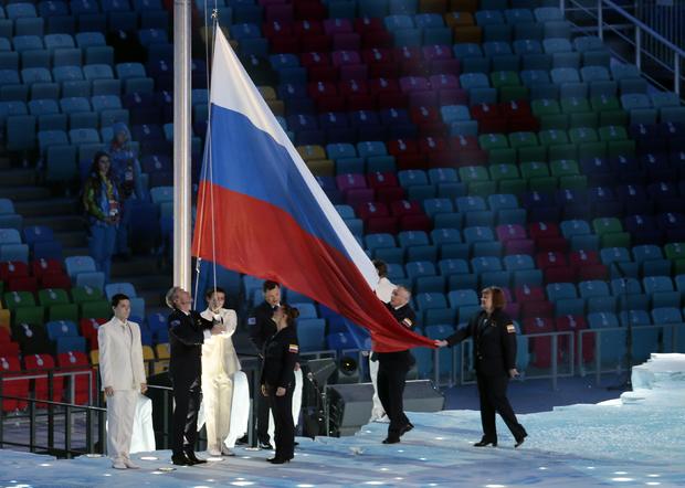 The flag of Russia is raised during the opening ceremony of the 2014 Winter Olympics in Sochi 