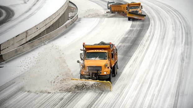 Snowplows clear downtown lanes on Interstate 75/85 during a winter storm Feb. 12, 2014, in Atlanta.