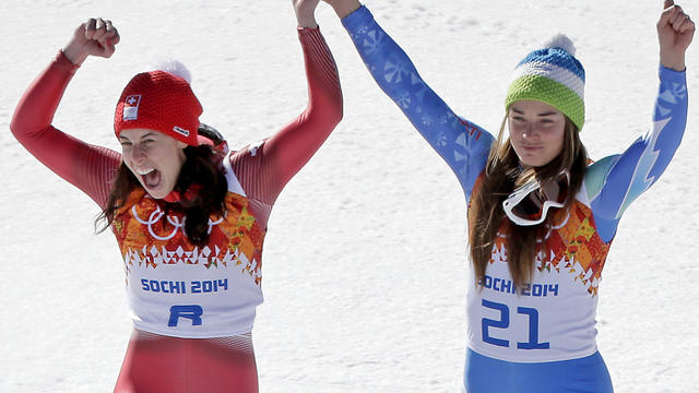 Women's downhill gold medal winners Switzerland's Dominique Gisin, left, and Slovenia's Tina Maze step onto the podium together 