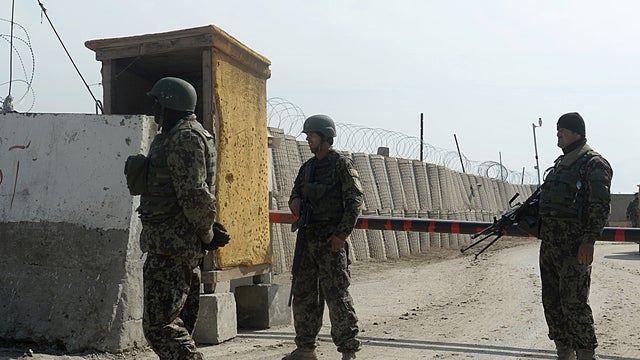 Afghan National Army (ANA) soldiers stand guard at the Bagram prison gate, about 30 miles north of Kabul 
