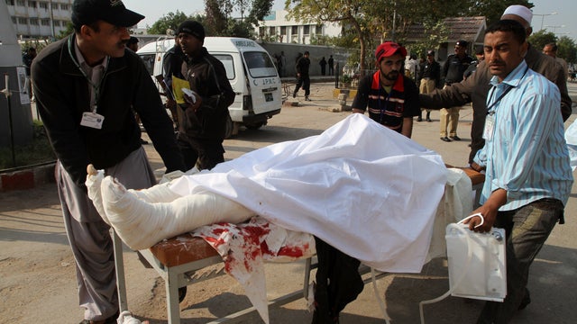A police officer, who was injured in a bombing targeting a police bus, is rushed to a hospital in Karachi, Pakistan 