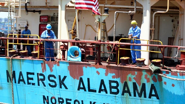 Crew members work aboard the U.S.-flagged Maersk Alabama after the ship docked in the harbor of Mombasa, Kenya, Nov. 22, 2009. 