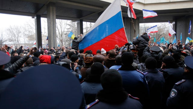 Pro-Russian demonstrators wave Russian flags during a protest in front of a local government building in Simferopol, Crimea, Ukraine 