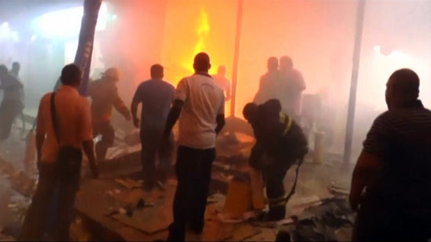 Crews work the scene after a deadly explosion at a supermarket in Quibdo, Colombia, Feb. 25, 2014. 