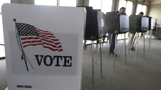 Voters cast their ballots in the Illinois primary Tuesday, March 18, 2014, in Hinsdale, Ill. 