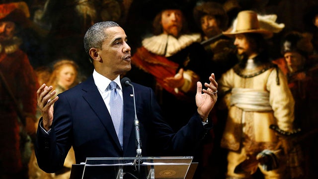 President Obama delivers a statement in front of Dutch master Rembrandt's The Night Watch painting during a visit to the Rijksmuseum in Amsterdam 