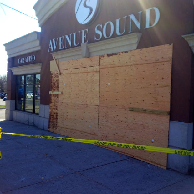 Avenue Sound in Patchogue is boarded up after a man in a stolen car plowed through the front windows 