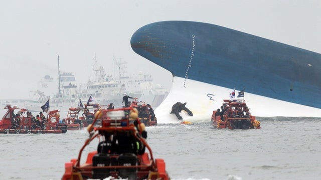 Part of the South Korean passenger ferry Sewol sticks out of the sea after sinking as maritime police search for passengers off Jindo, South Korea, April 16, 2014. 