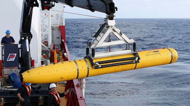 Crew aboard the Australian Defence Vessel Ocean Shield move the U.S. Navy's Bluefin-21 autonomous underwater vehicle into position for deployment 