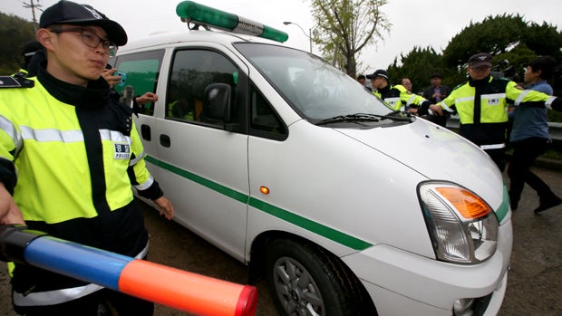 An ambulance transports the body of the high school vice principal who was found dead hanging from a tree April 18, 2014, in Jindo-gun, South Korea, in this handout image provided by Lee Hoon-Gu-Donga Daily. 