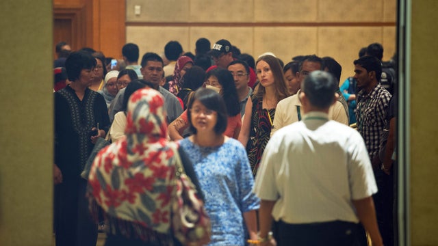Relatives of passengers on board missing Malaysia Airlines flight MH370 gather inside a room during a briefing at a hotel in Kuala Lumpur 
