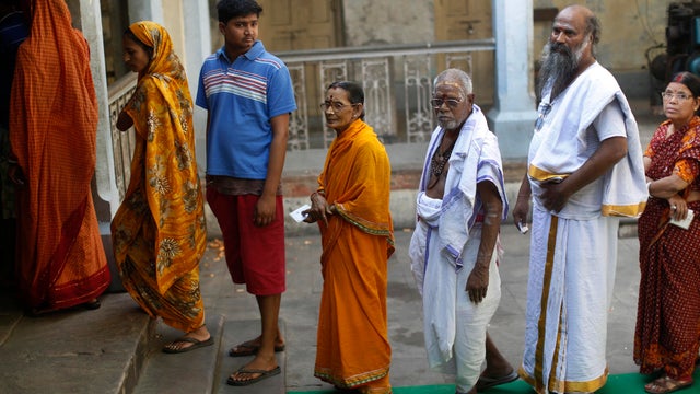 People wait to cast their vote at a polling station in the final phase of the general election in Varanasi in the northern Indian state of Uttar Pradesh  