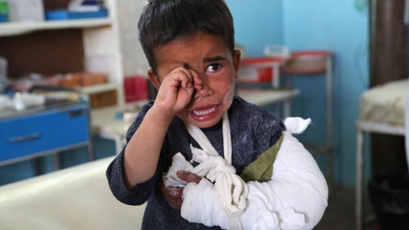 A wounded child cries after receiving treatment at a hospital following an attack in Ghazni province 
