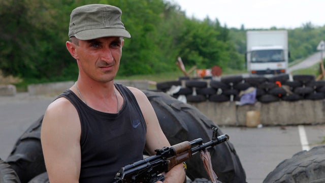 A pro-Russian activist guards a checkpoint outside the eastern Ukrainian village of Schastya May 14, 2014. 