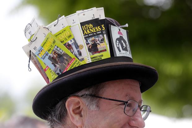 Kevin Corcoran wears a hat with past Preakness Stakes tickets in it before the 139th Preakness Stakes at Pimlico Race Course in Baltimore May 17, 2014. 