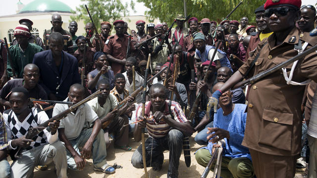 A vigilante group of traditional hunters poses for a picture at its camp in Maiduguri, Nigeria, May 21, 2014. 