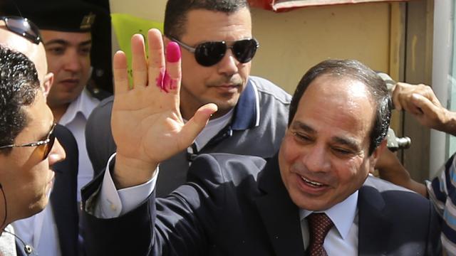 Presidential candidate and former army chief Abdel Fattah el-Sissi gestures after casting his ballot in Cairo 