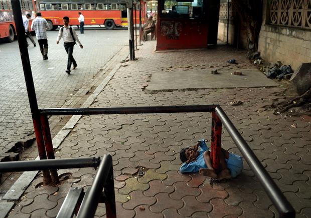 Disabled boy tied to sidewalk in India 