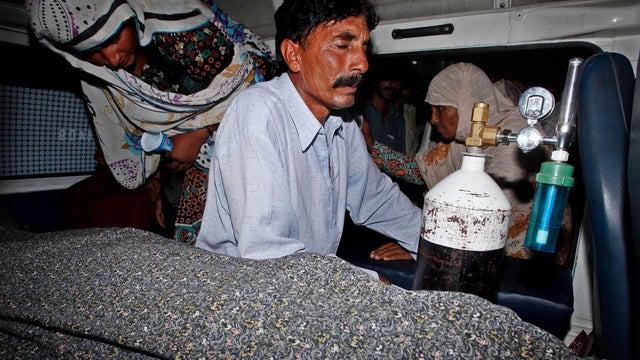 Pakistani relatives transport the body of a pregnant woman who was beaten to death with bricks by members of her own family for marrying a man of her own choice in Lahore 