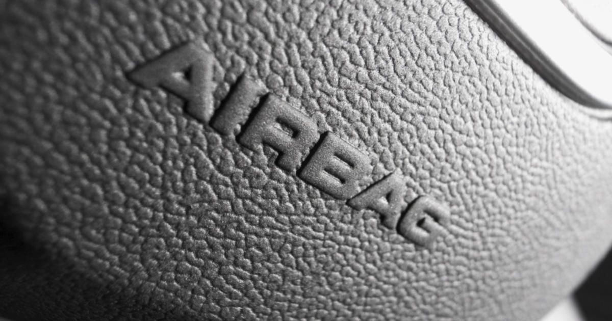 Close-up Shot of a Honda Logo with SRS AirBag on a Car Steering