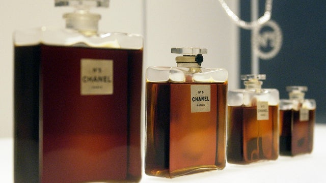 Four bottles of Chanel No. 5 perfume by Gabrielle Chanel from 1921, and a Chanel No. 5 necklace (R, rear) during a press preview of "Chanel", an exhibition of the history of the fashion House of Chanel at the Metropolitan Museum of Art in New York. 