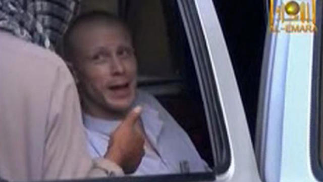 U.S. Army Sgt. Bowe Bergdahl, right, talks to a Taliban militant as he waits in a pick-up truck before his release at the Afghan border in this still image from video released June 4, 2014. 