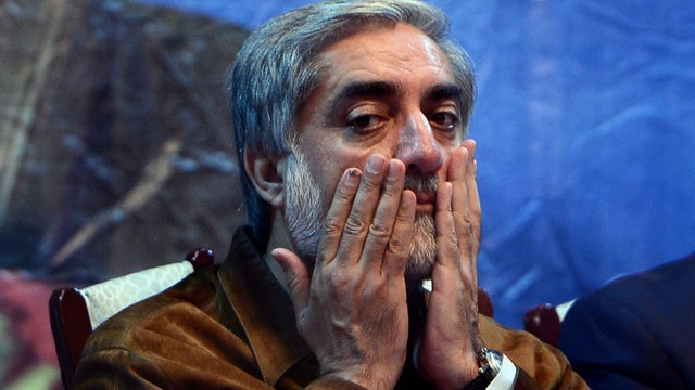 Afghan presidential candidate Abdullah Abdullah prays at an election gathering after surviving a suicide attack  