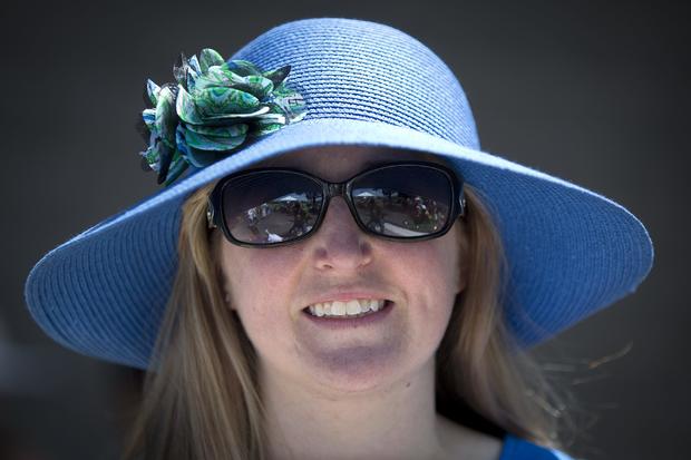 Julia Logan poses for a portrait with her colorful hat before the 146th running of the 2014 Belmont Stakes in Elmont, New York, June 7, 2014. 