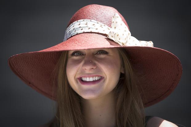 Christina Hudson poses for a portrait with her colorful hat before the 146th running of the 2014 Belmont Stakes in Elmont, New York, June 7, 2014. 