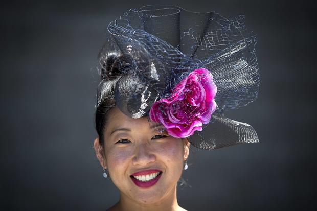 Anne Heffernan poses for a portrait with her colorful hat before the 146th running of the 2014 Belmont Stakes in Elmont, New York, June 7, 2014. 