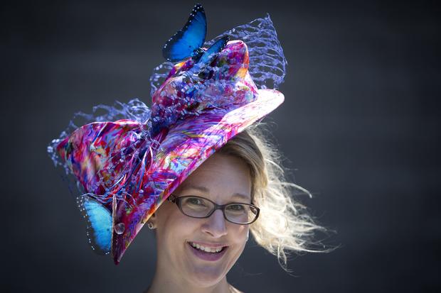 Andrea O'Halloran poses for a portrait with her colorful hat before the 146th running of the 2014 Belmont Stakes in Elmont, New York, June 7, 2014. 