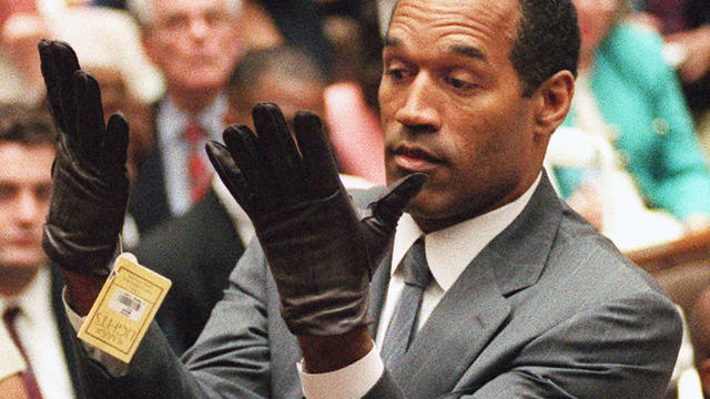 O.J. Simpson holds up his hands before the jury after putting on a new pair of gloves similar to the infamous bloody gloves during his double-murder trial in Los Angeles on June 21, 1995. 