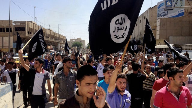 Demonstrators chant in support of al Qaeda-inspired Islamic State of Iraq and Syria as they carry al Qaeda flags in front of the provincial government headquarters in Mosul, Iraq, 225 miles northwest of Baghdad, June 16, 2014. 