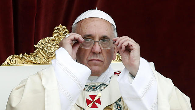 Pope Francis adjusts his glasses as he leads at the feast of Corpus Christi (Body of Christ) at St. Givanni in Laterano Basilica in Rome June 19, 2014. 
