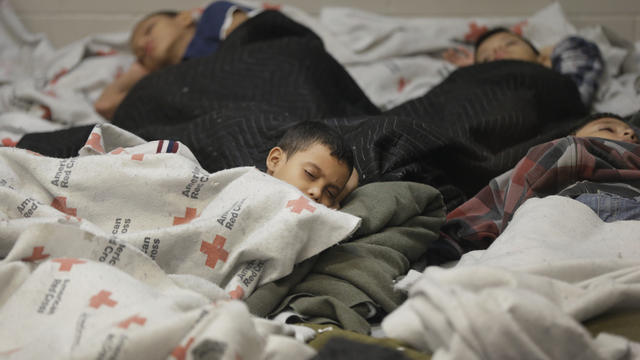 June 18, 2014, file photo shows children detainees sleeping in a holding cell at a U.S. Customs and Border Protection processing facility in Brownsville,Texas 