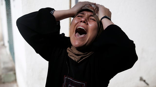 The mother of one of the four Palestinian children from the Baker family grieves outside the morgue in Gaza City July 16, 2014. 