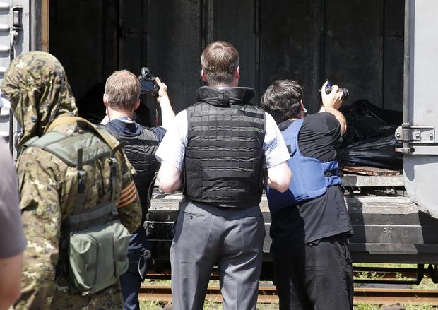 Monitors from the OSCE inspect a refrigerator wagon holding bodies of passengers from Malaysia Airlines flight 17 