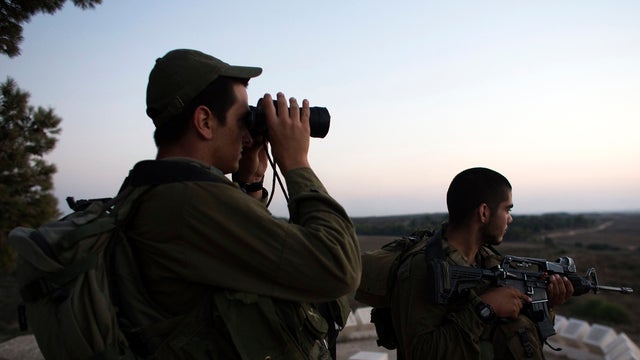 Israeli soldiers stand near the border with the Gaza Strip July 26, 2014. 
