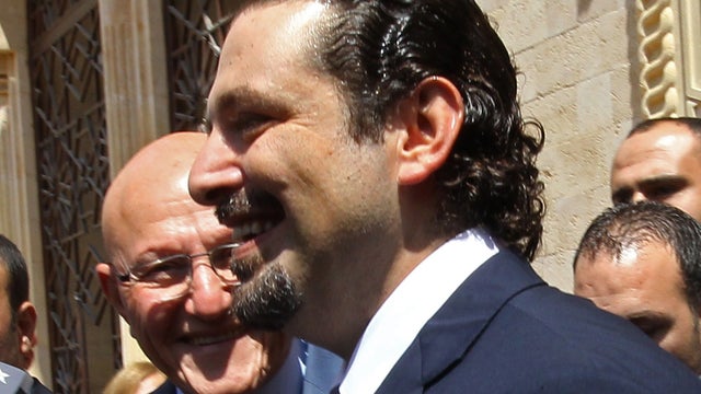 Former Lebanese premier Saad Hariri (R) walks with current Prime Minister Tammam Salam (L) 