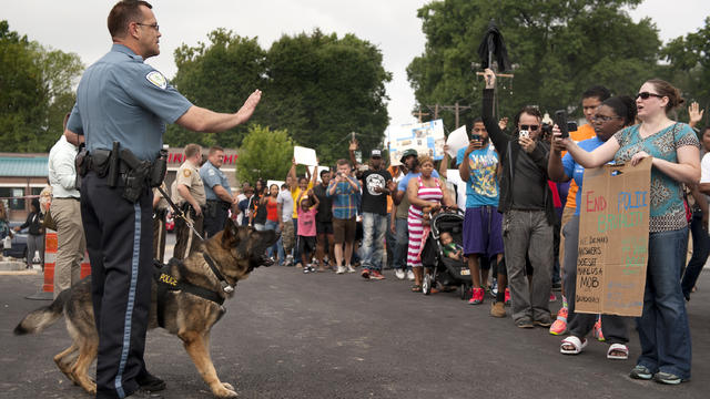 Protestors confront police during an impromptu rally, Aug. 10, 2014, to protest the shooting of Michael Brown 