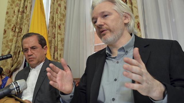 WikiLeaks founder Julian Assange speaks as Ecuador's Foreign Affairs Minister Ricardo Patino listens 