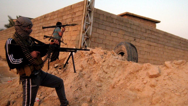 A picture taken Jan. 21, 2014, shows anti-government fighters aiming their weapons as they hold a position in the Anbar city of Fallujah, Iraq. 