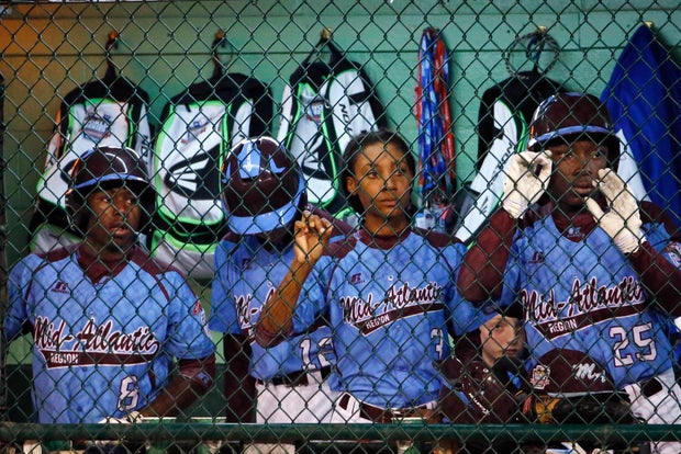 Philadelphia pitcher Mo'ne Davis, center, stands in the dugout with teammates Jahli Hendricks (8) and Zion Spearman (25) in the sixth inning of a semi-final baseball game against Las Vegas at the Little League World Series tournament in South Williamsport 