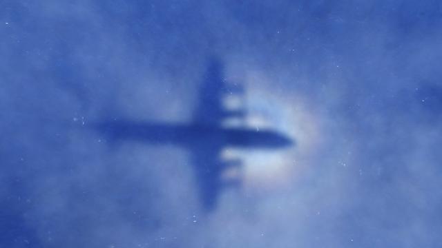 ​This shadow of a Royal New Zealand Air Force P3 Orion aircraft is seen on low cloud cover while it searches for missing Malaysia Airlines Flight 370 over the Indian Ocean March 31, 2014. 