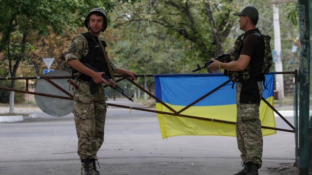 Soldiers stand guard at the base of Ukrainian self-defense battalion "Azov" in the southern coastal town of Mariupol 