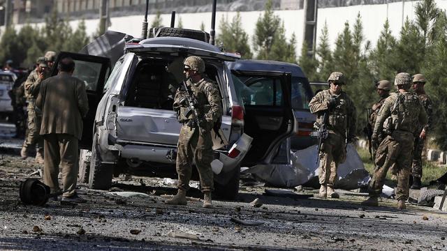 U.S. troops keep watch at the site of a suicide attack in Kabul  