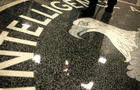 A man walks across the seal of the Central Intelligence Agency at the lobby of the Original Headquarters Building at the CIA headquarters Feb. 19, 2009, in McLean, Virginia. 
